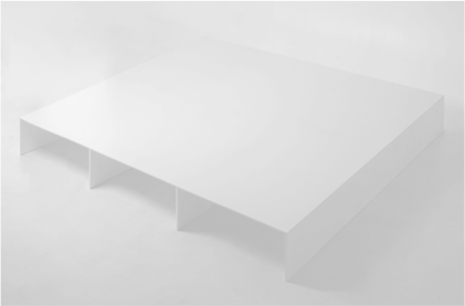 Close-up of a minimalist white bed platform, focusing on the edge of the platform and two of the vertical support panels underneath. 